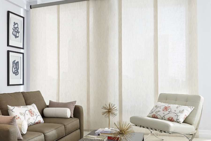White translucent shades on a tall living room window